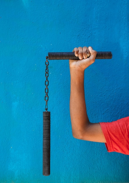 Photo high angle view of man holding metal against blue wall