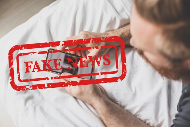 High angle view of man holding text on bed