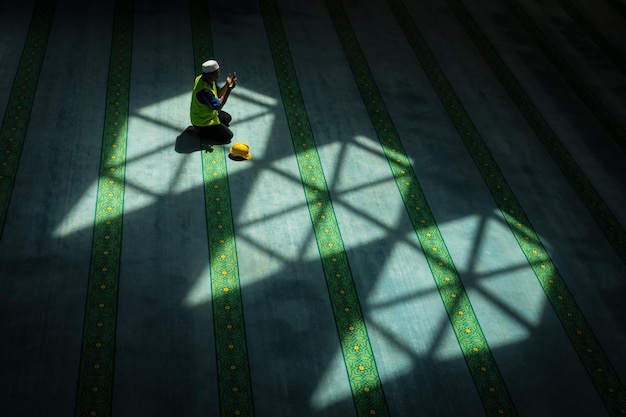 High angle view of man praying in mosque