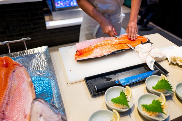 High angle view of man preparing fish on table