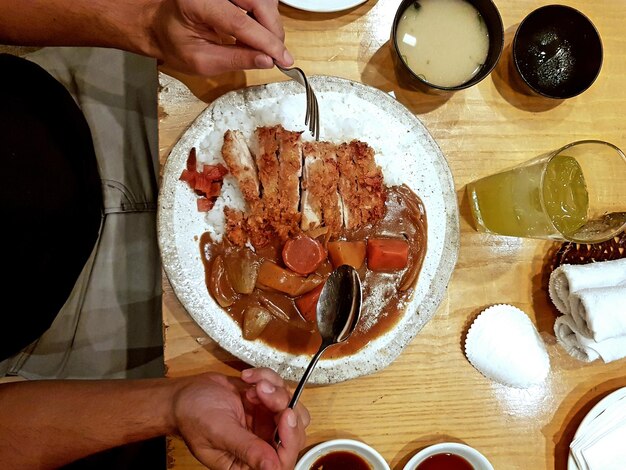 High angle view of man preparing food on table