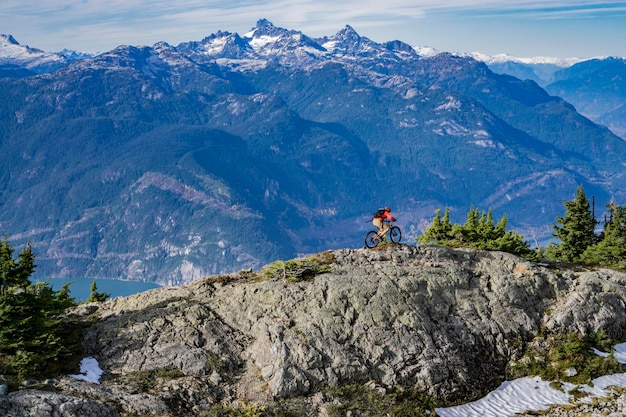 High angle view of man riding bicycle on mountain during winter