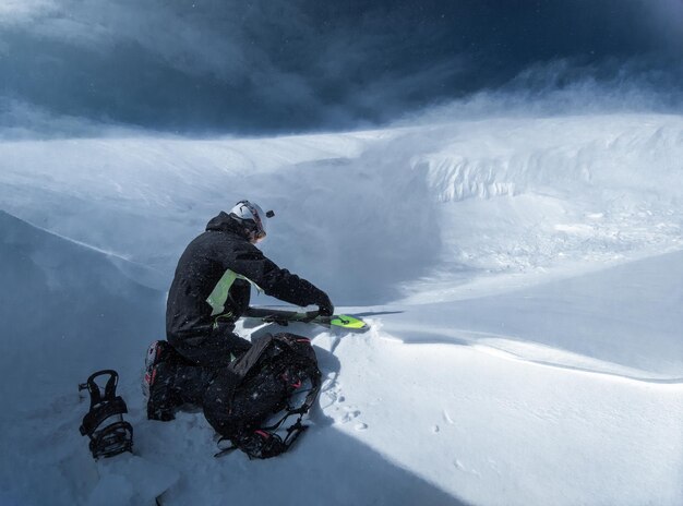 Photo high angle view of man on snowcapped mountain during winter