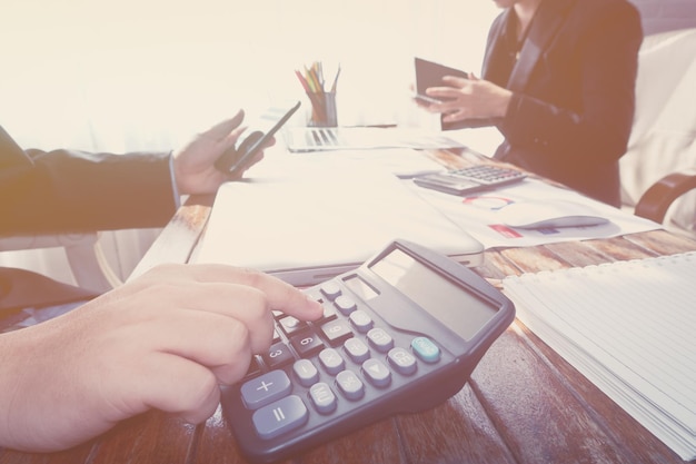 high angle view of man using calculator at desk
