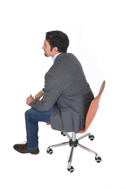 High angle view of a man with blazer sitting ,rear view, on white background