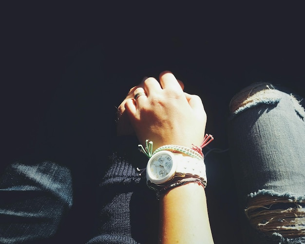 High angle view of man and woman holding hands while sitting outdoors