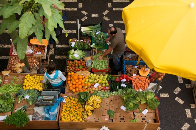 High angle view of man and woman at market stall