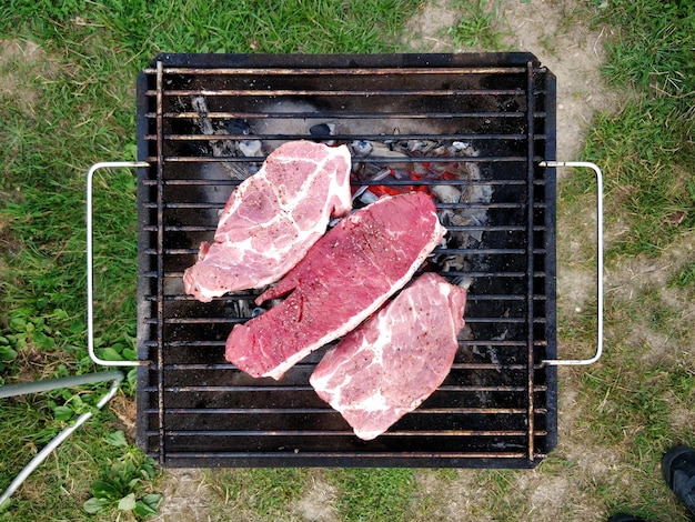 High angle view of meat on barbecue grill