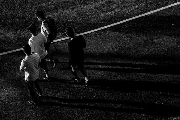 Photo high angle view of men walking on road