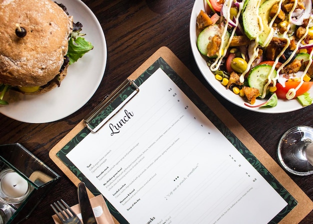 High angle view of menu and food in plate on table