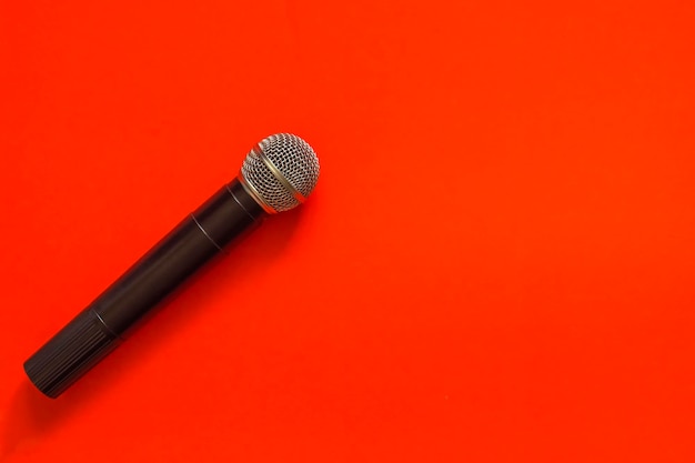 High angle view of microphone against orange background