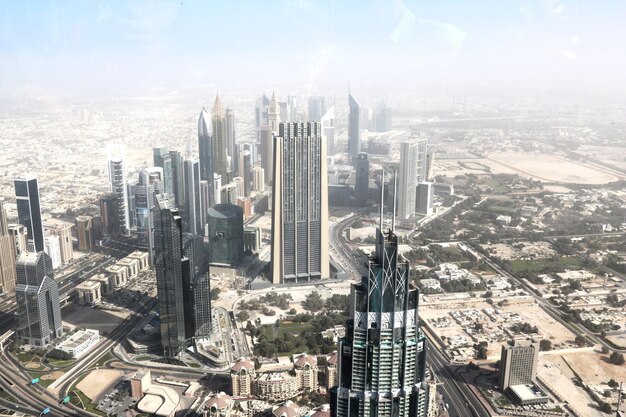 High angle view of modern buildings in city against sky