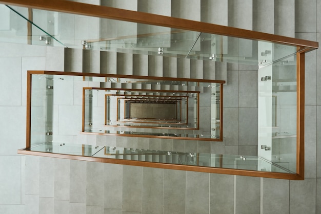 High angle view of modern stairs with glass railings in the building
