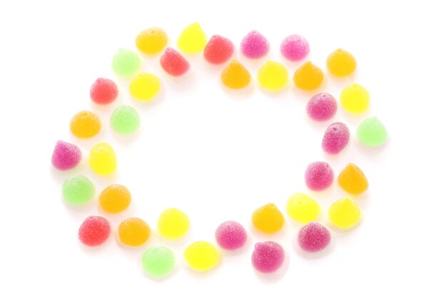 High angle view of multi colored candies against white background