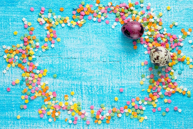 Photo high angle view of multi colored candies on blue background