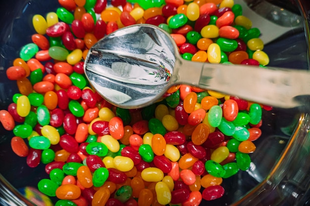 High angle view of multi colored candies in container