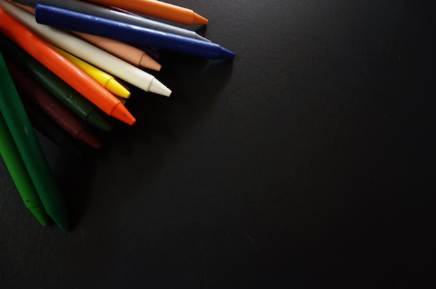High angle view of multi colored crayons on table