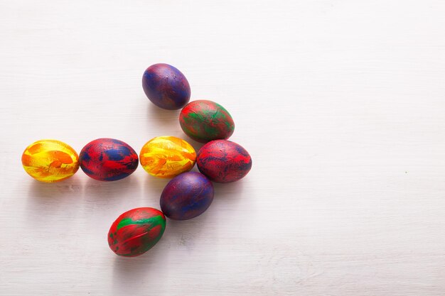 High angle view of multi colored eggs on table