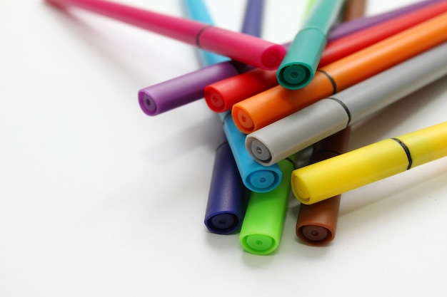 High angle view of multi colored felt tip pens against white background