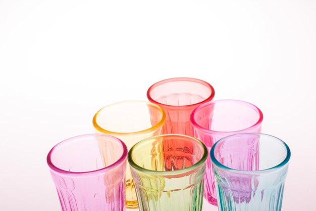 High angle view of multi colored glass on white background