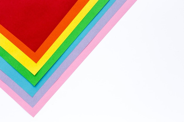 High angle view of multi colored papers against white background