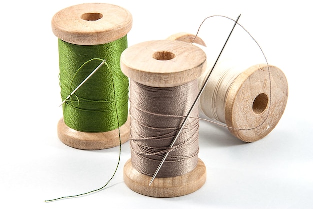high angle view of multi colored spools against white background