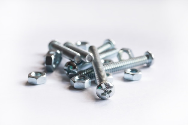 Photo high angle view of nuts and bolts against white background