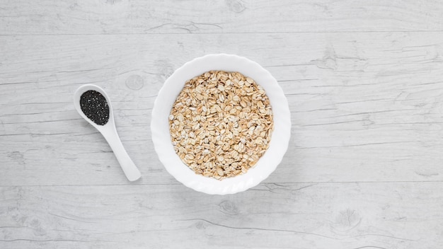 High angle view of oats and chia seeds over wooden table