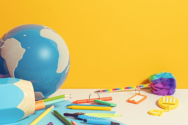 High angle view of objects on table against yellow background