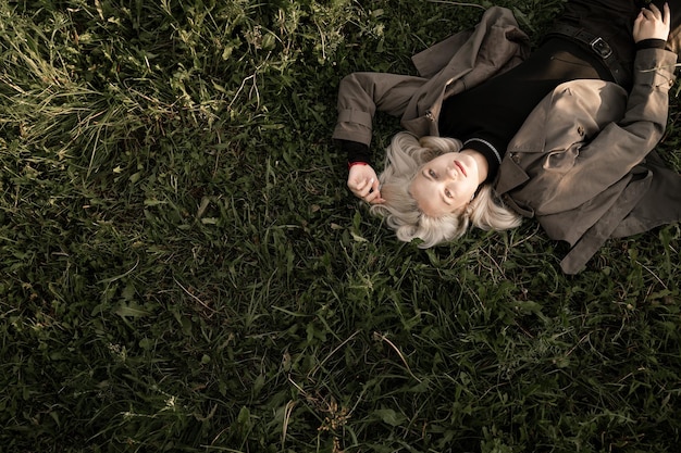 Фото Высокоугольный вид девушки, лежащей на траве