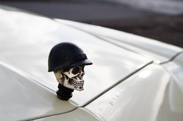 Фото Высокоугольный вид человеческого черепа на капоте автомобиля