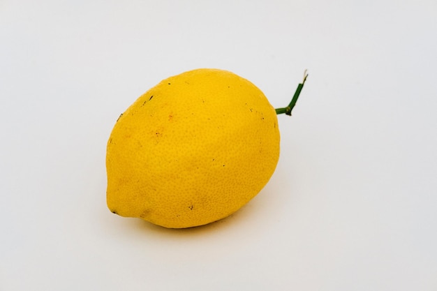 Фото Высокоугольный вид лимонного кусочка на белом фоне