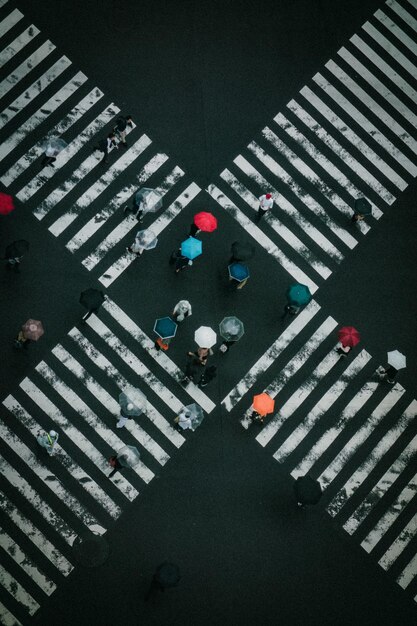 写真 道路を歩いている間,傘を握っている人々の高角度の景色