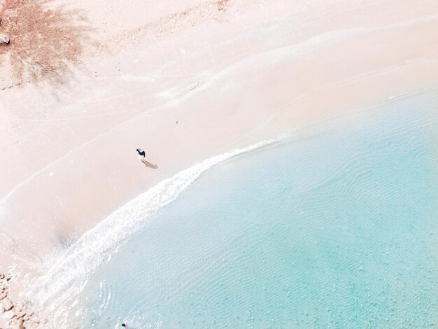 写真 海岸で歩いている女性の高角度の写真