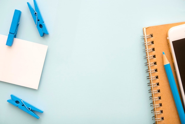 high angle view of office supplies on blue background