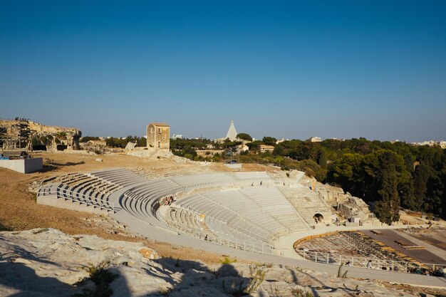 High angle view of old ruins against blue sky