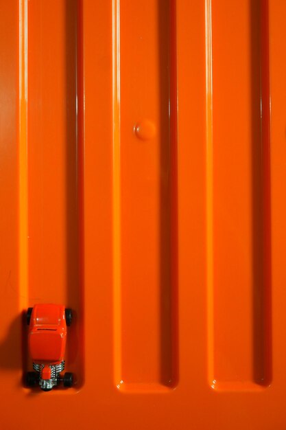 High angle view of orange car on table against wall