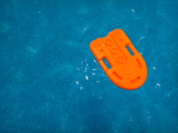 High angle view of orange floater on swimming pool