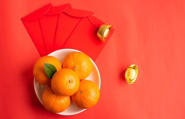 High angle view of orange fruits against red background