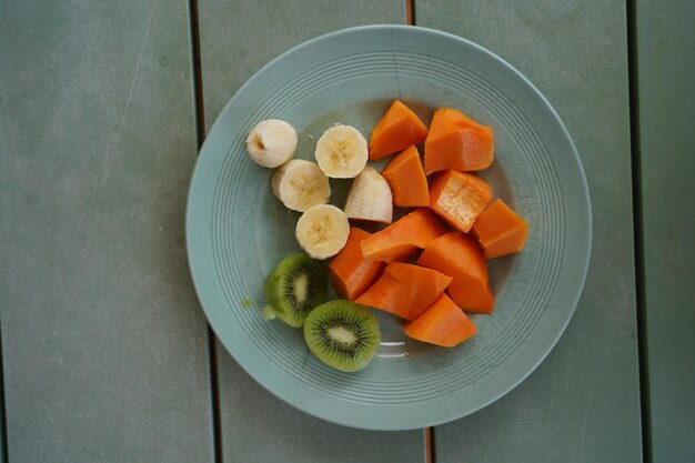 High angle view of orange fruits in plate on table