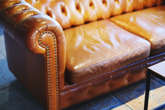 Photo high angle view of orange on  vintage leather sofa