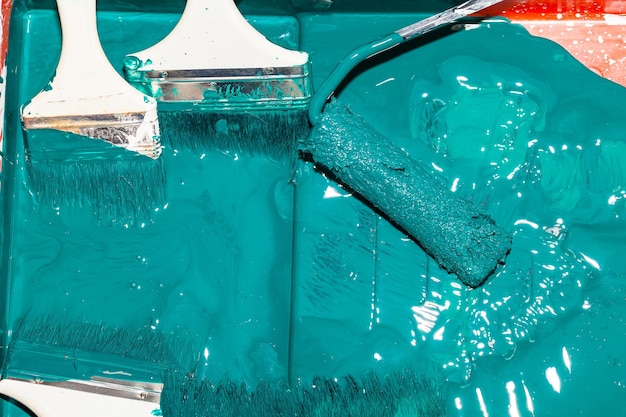 High angle view of paintbrush and roller