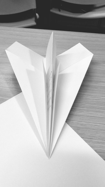 High angle view of paper airplane on table