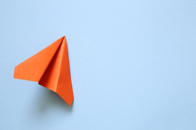 Photo high angle view of paper plane on blue background