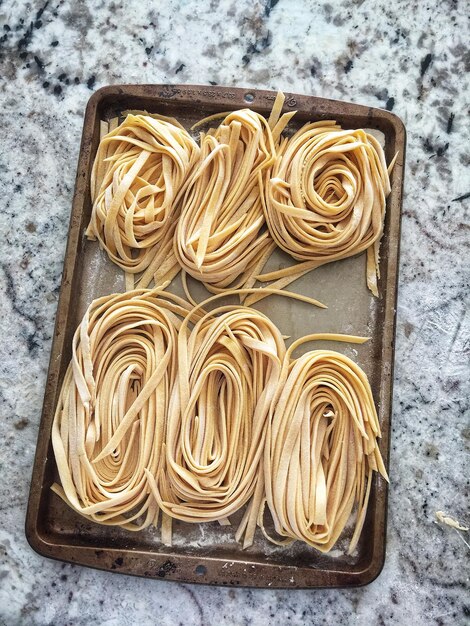 Foto vista ad alto angolo della pasta nel foglio da cottura sul tavolo