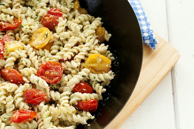 Foto vista ad alto angolo della pasta con i pomodori in ciotola sul tavolo