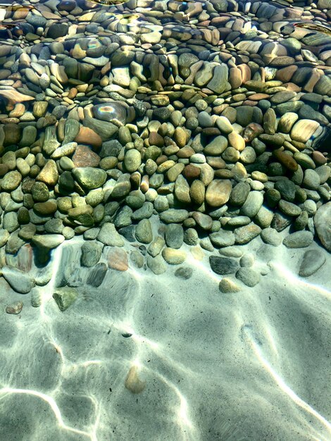 High angle view of pebbles on beach