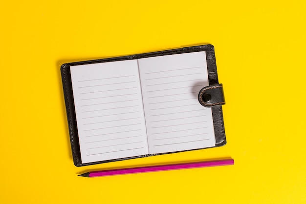 High angle view of pen against yellow background