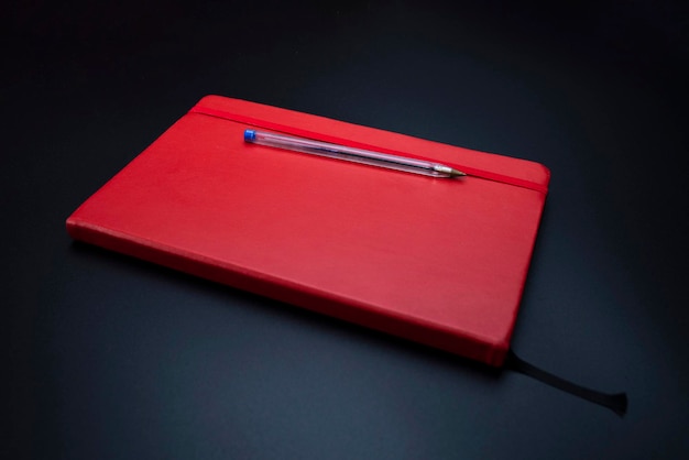 High angle view of pen and book against black background