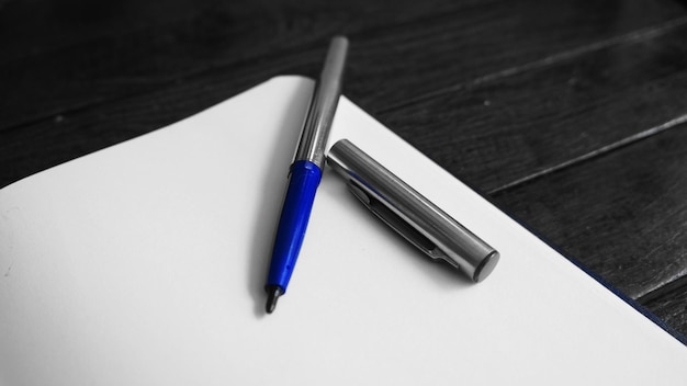 High angle view of pen and paper on table